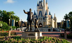 A statue of Walt Disney and Mickey Mouse in front of Cinderella’s Castle greets visitors at the Magic Kingdom.